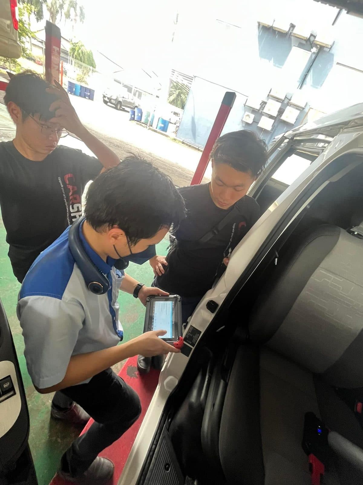 CarShifu technicians running a diagnostic scan tool at a car during a breakdown call in KL