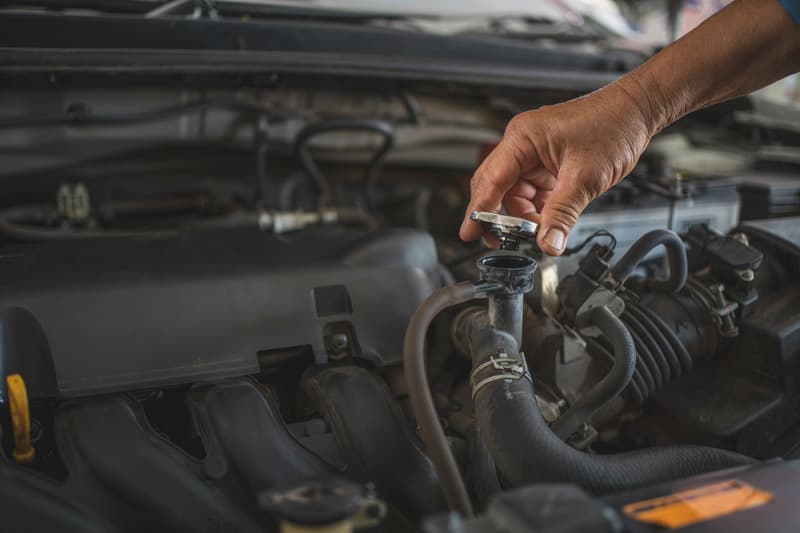 Mechanic working in an open engine bay on a service call