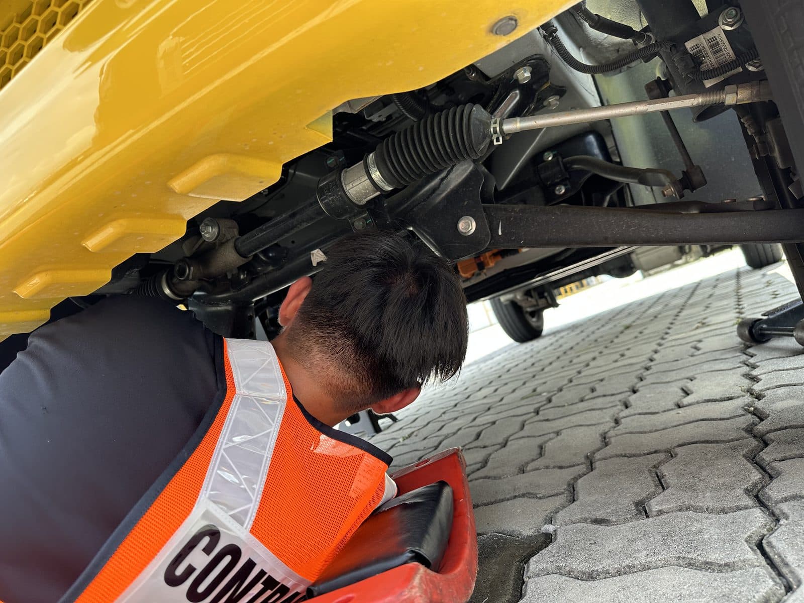 Close-up of steering and suspension repair under a commercial van during a CarShifu lorry job in KL