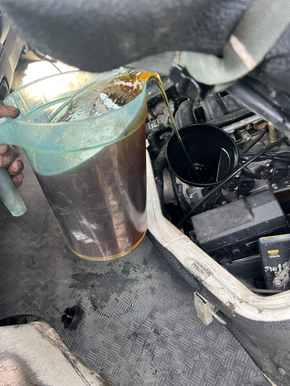 Engine oil being poured into engine bay during scheduled preventive maintenance